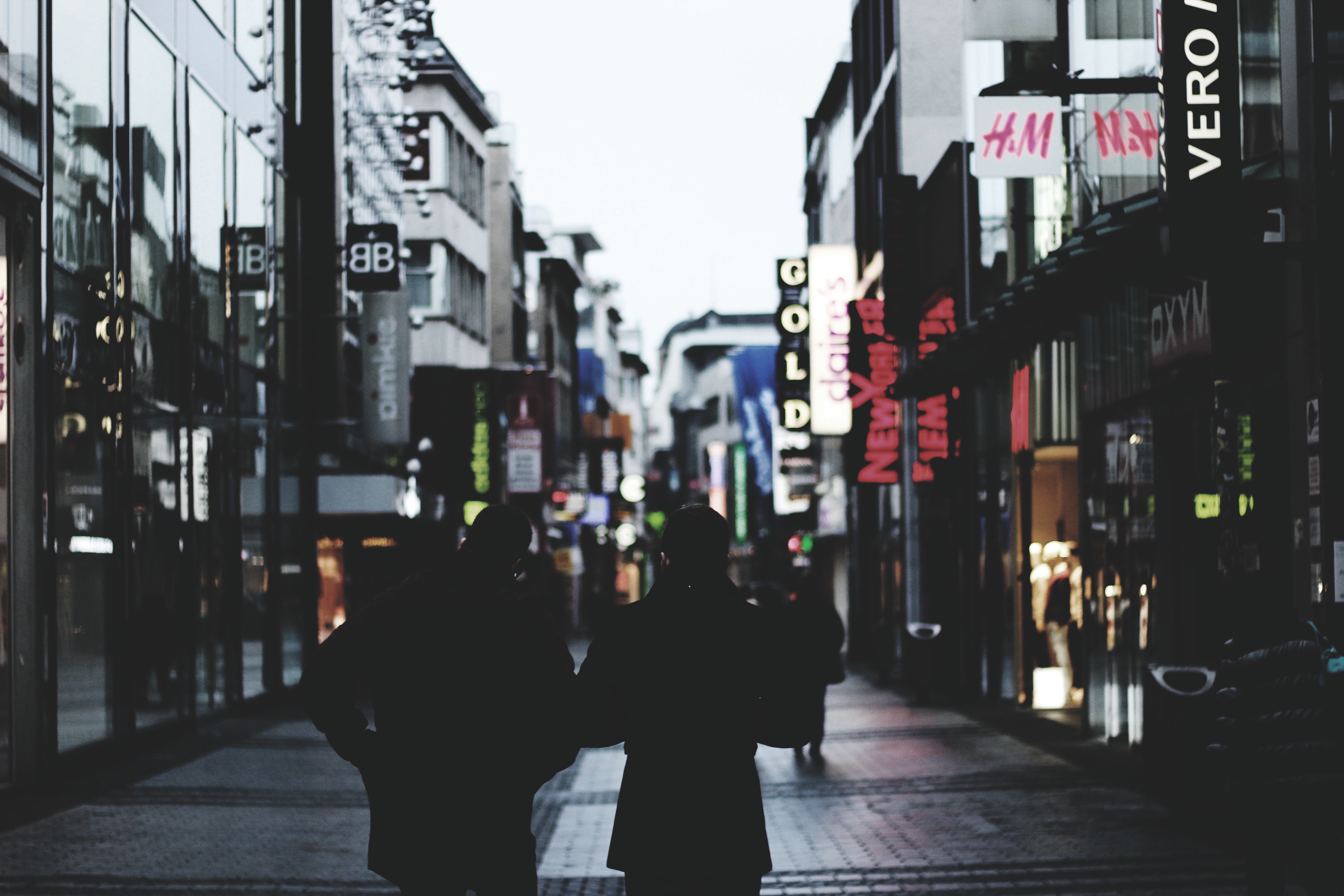 Two men walking away down the street