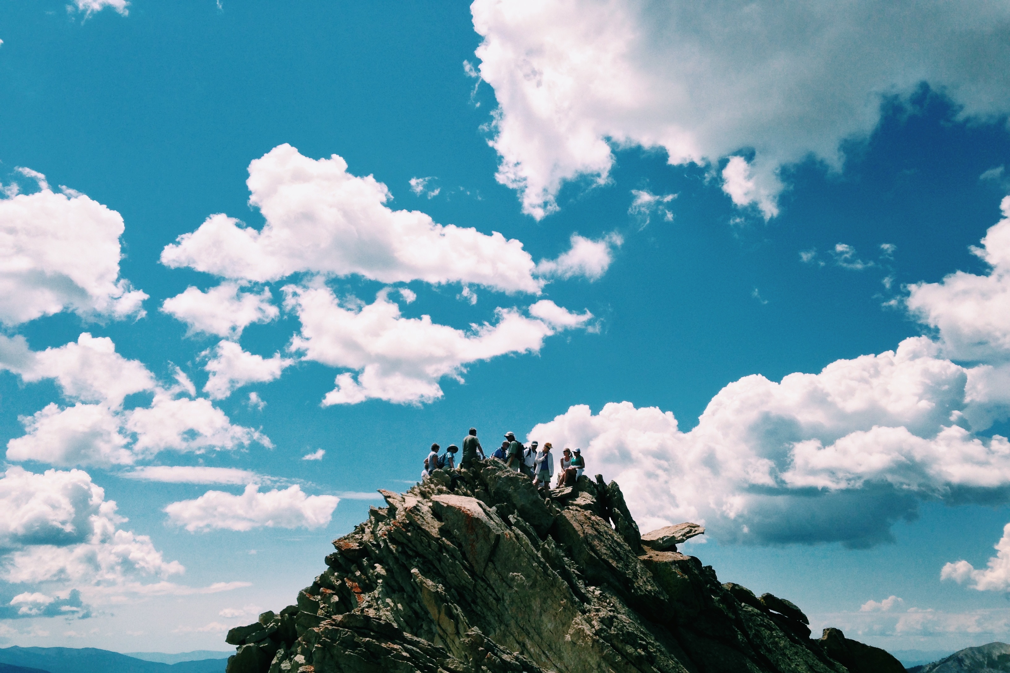 image of a group of 9 people on top of a mountain - IBEX Payroll is a Canadian online payroll service focused on small business and non-profits.