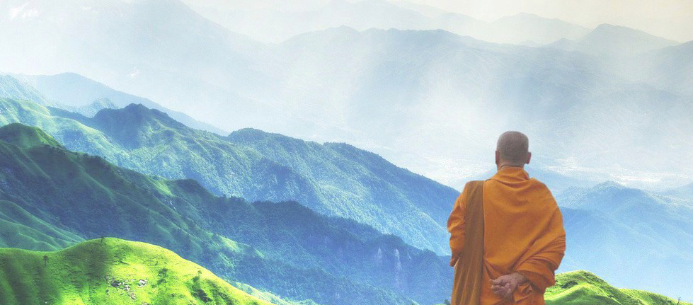 Photo of a monk overlooking mountains