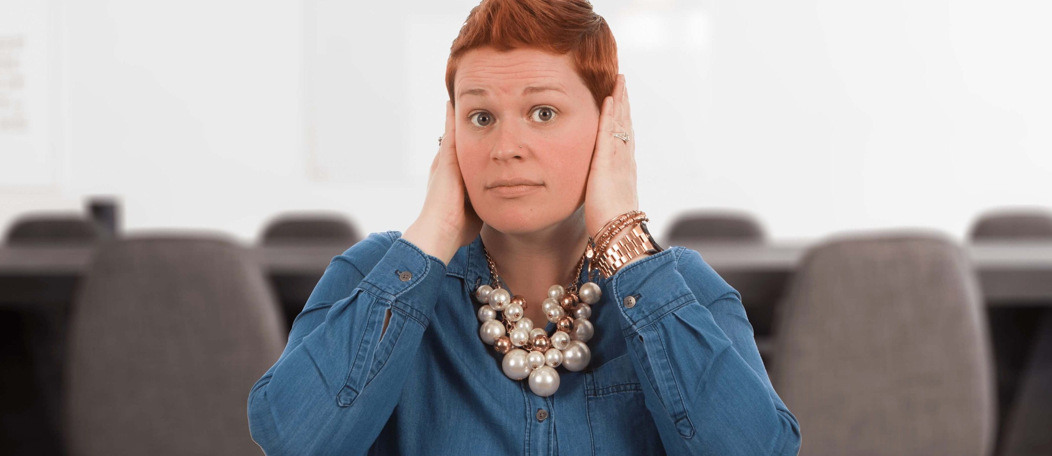 A woman covering her ears