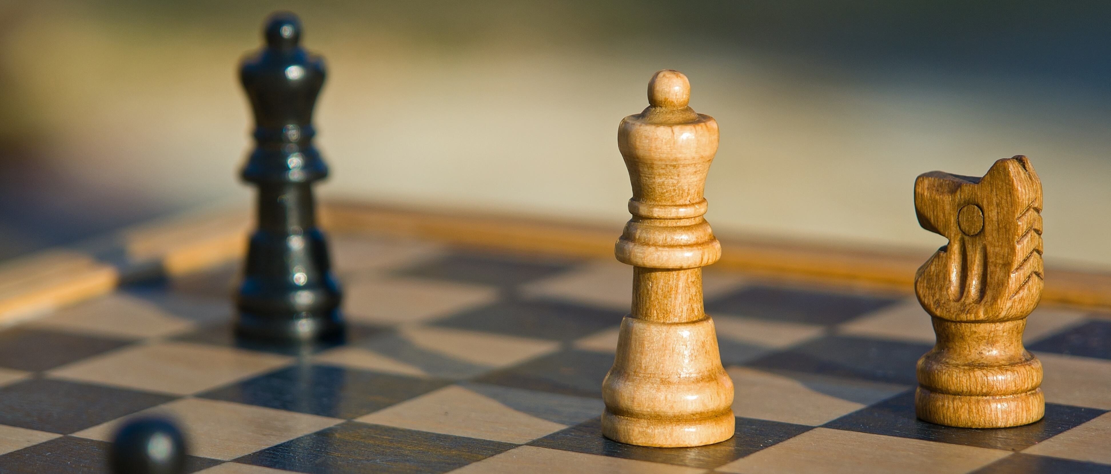 Chess pieces lit by low light